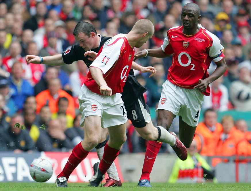 Manchester United&#039;s Wayne Rooney, rear left, takes on Arsenal&#039;s Philippe Senderos, center, and Patrick Vieira during the FA Cup Final at the Millennium Stadium in Cardiff, Wales Saturday May ...