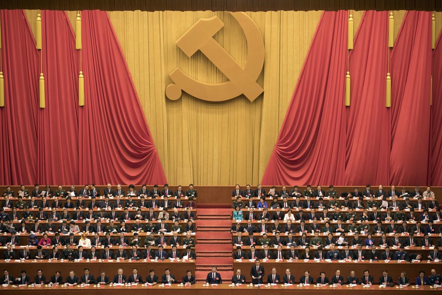 In this Wednesday, Oct. 18, 2017, file photo, Chinese President Xi Jinping, center, presides over the opening ceremony of the 19th Party Congress held at the Great Hall of the People in Beijing Wednes ...