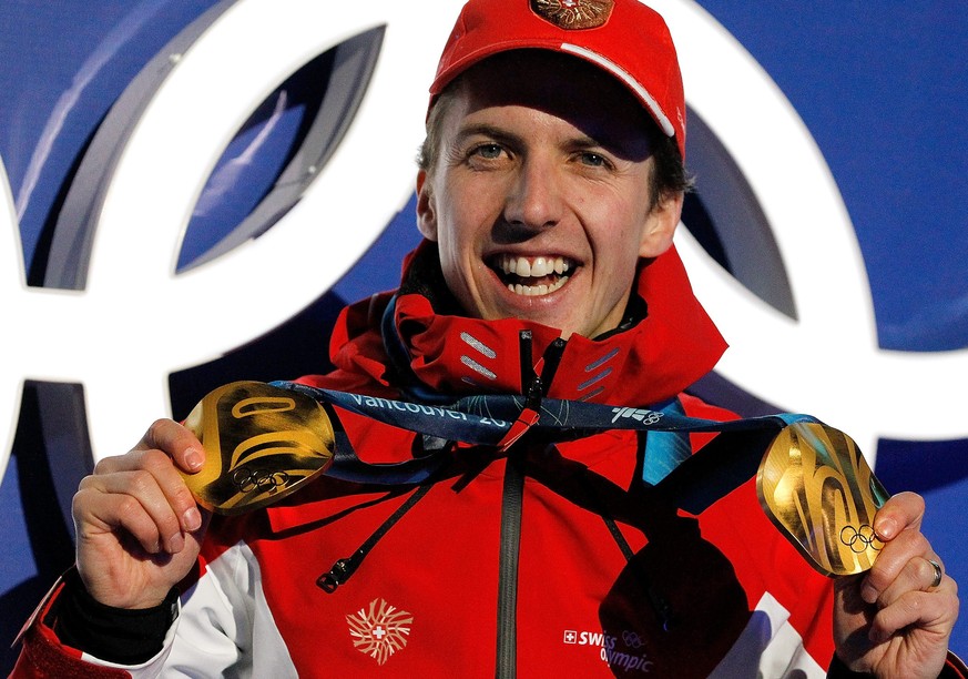 Simon Ammann of Switzerland shows his two gold medals for the ski jumping competition during the medal ceremony at the XXI Olympic Winter Games Vancouver 2010 in the Whistler Olympic Park in Whistler  ...