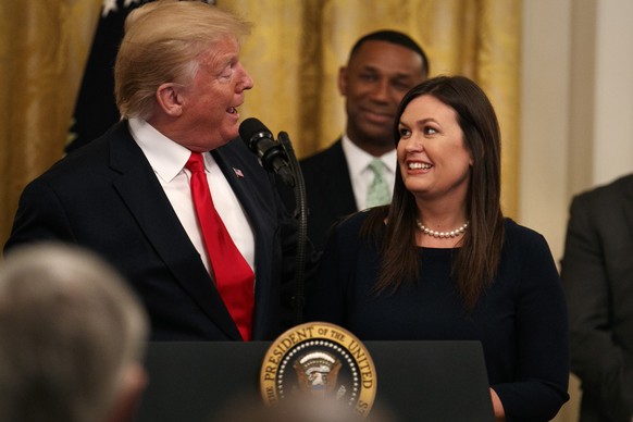 President Donald Trump welcomes White House press secretary Sarah Sanders to the stage as he pauses from speaking about second chance hiring to publicly thank the outgoing press secretary in the East  ...