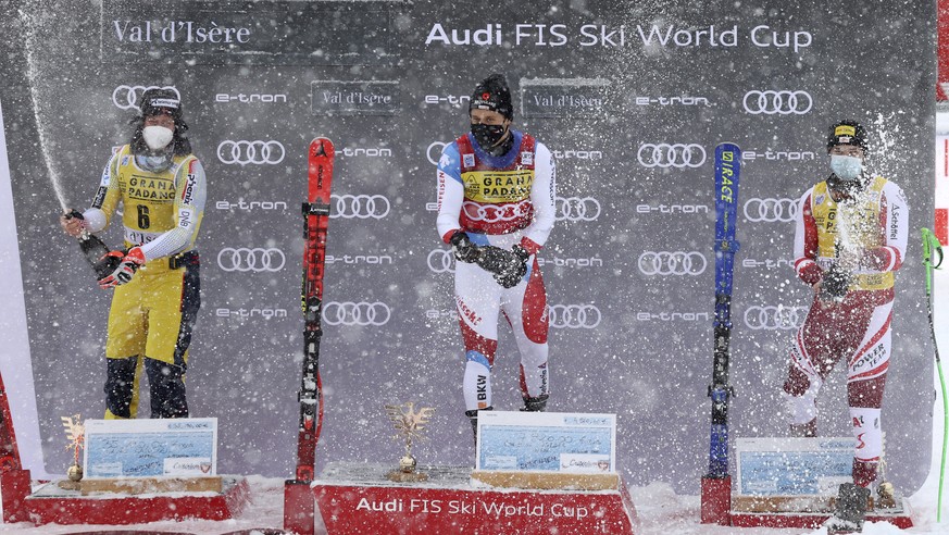 From left, Norway&#039;s Adrian Smiseth Sejersted, second placed, Switzerland&#039;s Mauro Caviezel, the winner, and Austria&#039;s Christian Walder, third, celebrate on podium after an alpine ski men ...