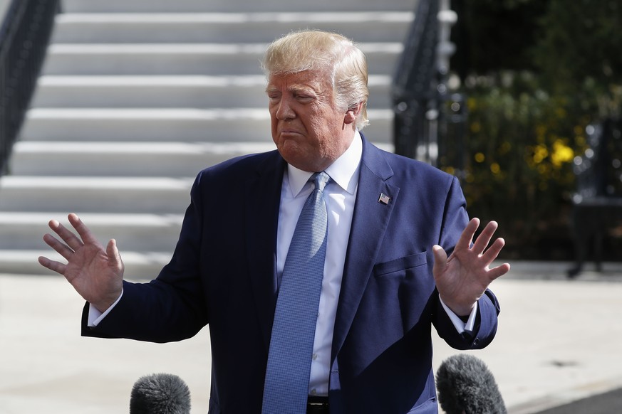 President Donald Trump gestures while speakings to the media on the South Lawn of the White House in Washington, Friday, Oct. 4, 2019, before his departure to nearby Walter Reed National Military Medi ...