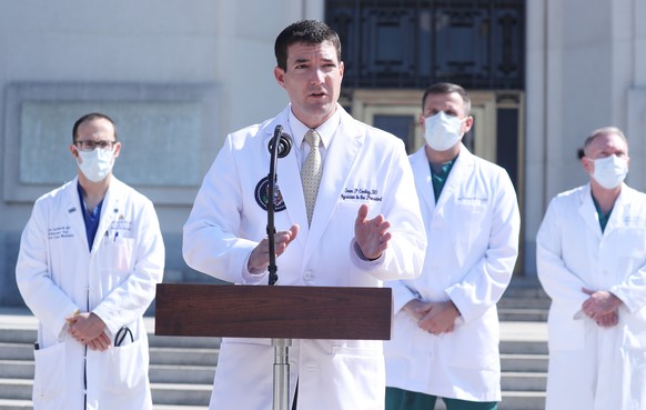 epa08720429 Commander Sean P. Conley (C), Physician to the President, gives an update on the condition of US President Donald J. Trump at the Walter Reed National Military Medical Center in Bethesda,  ...
