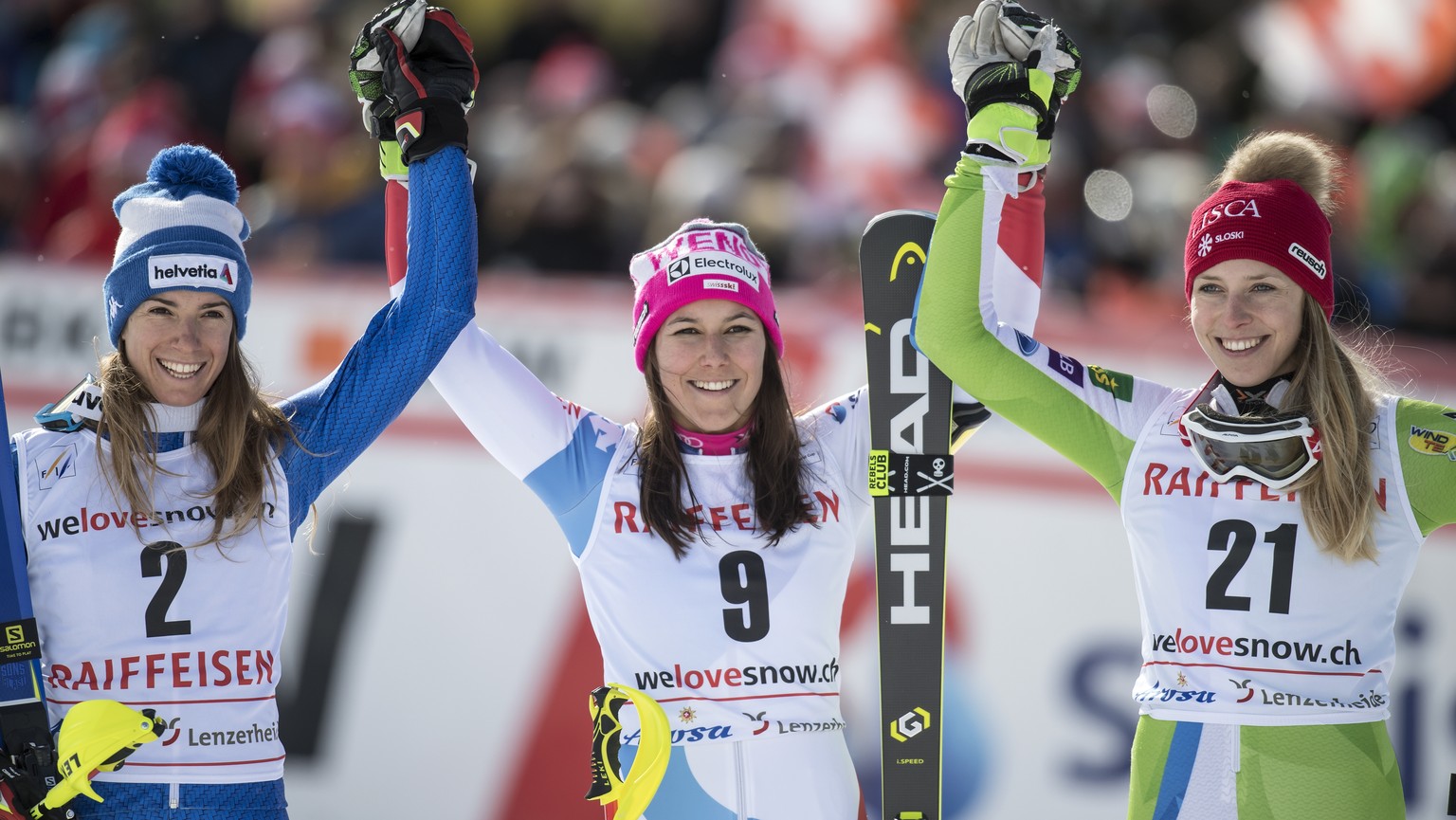 Winner Wendy Holdener of Switzerland, center, poses with second placed Marta Bassino of Italy, left, and third placed Ana Bucik of Slovenia, right, during the podium ceremony after the Slalom run of t ...