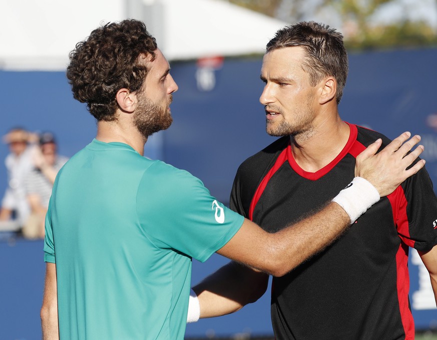 epa05514713 Marco Chiudinelli of Switzerland (R) and Guillherme Clezar of Brazil after their match on the first day of the US Open Tennis Championship at the USTA National Tennis Center in Flushing Me ...