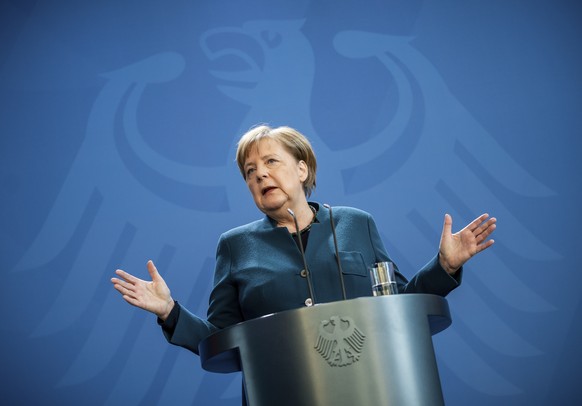 German Chancellor Angela Merkel speaks at a press conference about coronavirus, in Berlin, Sunday, March 22, 2020. German Chancellor Angela Merkel has gone into quarantine after being informed that a  ...