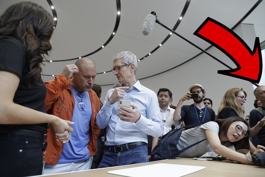 Apple CEO Tim Cook, center, and Jonathan Ive, second from left, Chief Design Officer shows the new iPhone X in the showroom after the new product announcement at the Steve Jobs Theater on the new Appl ...