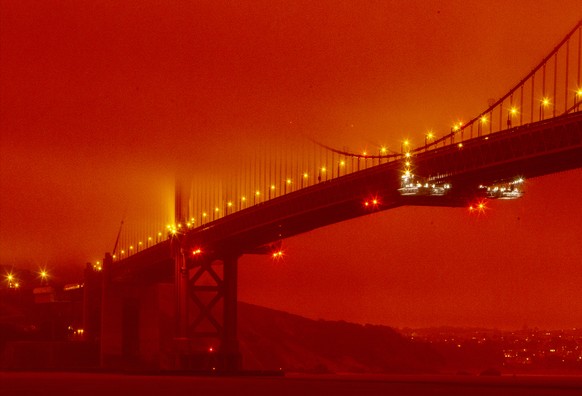 In this photo provided by Frederic Larson, the Golden Gate Bridge is seen at 11 a.m. PT amid a smoky, orange hue caused by the ongoing wildfires, Wednesday, Sept. 9, 2020, in San Francisco. (Frederic  ...
