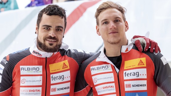 Third placed Clemens Bracher and Michael Kuonen of Switzerland pose for media after the men&#039;s two-man bobsled World Cup race in Innsbruck, Saturday, Dec. 16, 2017. (AP Photo/Kerstin Joensson)