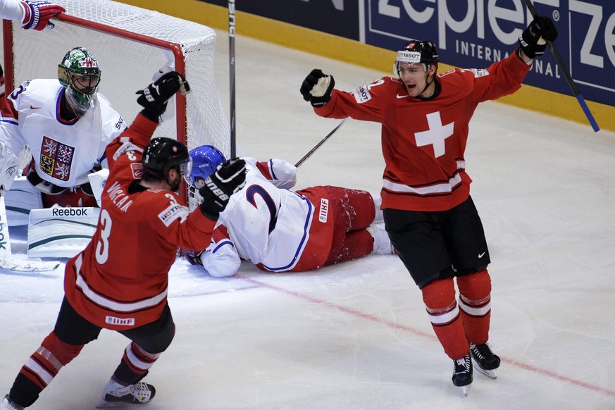 Switzerland&#039;s Nino Niederreiter, right, celebrates his goal with teammate Julien Vauclair, left, after scored the 2:0, during the IIHF Ice Hockey World Championships preliminary round game Switze ...