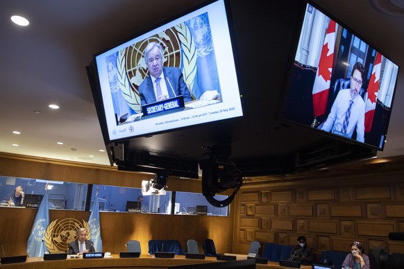 In this photo provided by the United Nations, Secretary-General Antonio Guterres, on screen at left, addresses a meeting on financing the 2030 Agenda for Sustainable Development in the era of COVID-19 ...