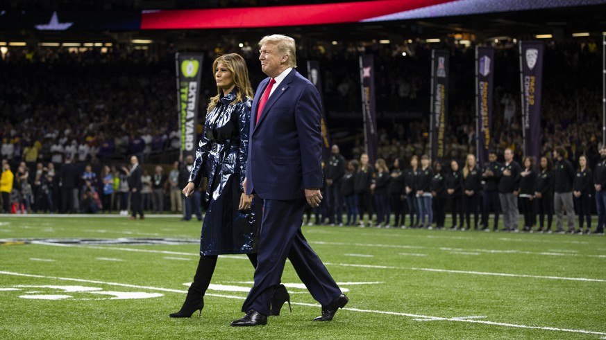 President Donald Trump and first lady Melania Trump arrive for the College Football Playoff National Championship game between LSU and Clemson, Monday, Jan. 13, 2020, in New Orleans. (AP Photo/ Evan V ...