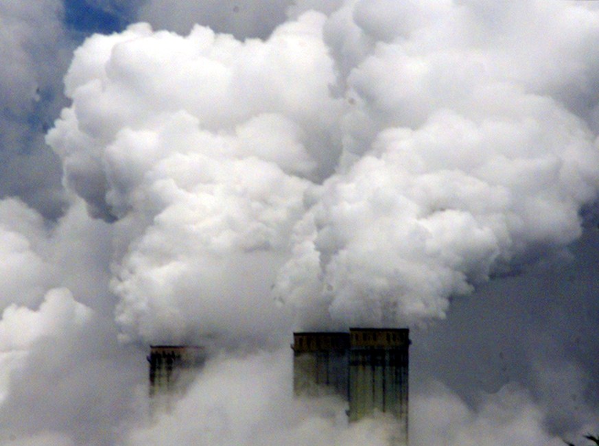 FILE - In this file photo dated Wednesday Feb. 7, 2001, chimneys of an energy plant near the lignite mining Garzweiler, Germany. Villagers living near the vast German Garzweiler coal mine said Wednesd ...