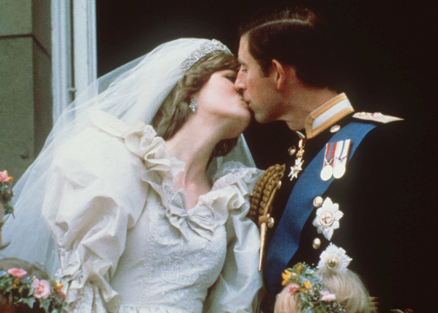 FILE - In this July 29, 1981 file photo, Britain&#039;s Prince Charles kisses his bride, the former Diana Spencer, on the balcony of Buckingham Palace in London after their wedding. Thirty-six years a ...