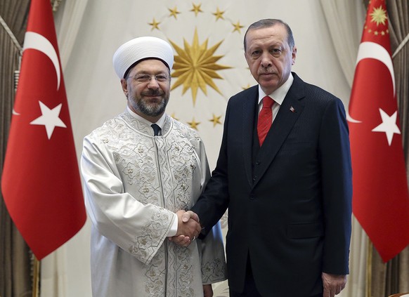 Turkey&#039;s President Recep Tayyip Erdogan, right, shakes hands with Ali Erbas, Chief of Religious Affairs, at his palace in Ankara, Turkey, Wednesday, Sept. 27, 2017. Erdogan&#039;s office has conf ...