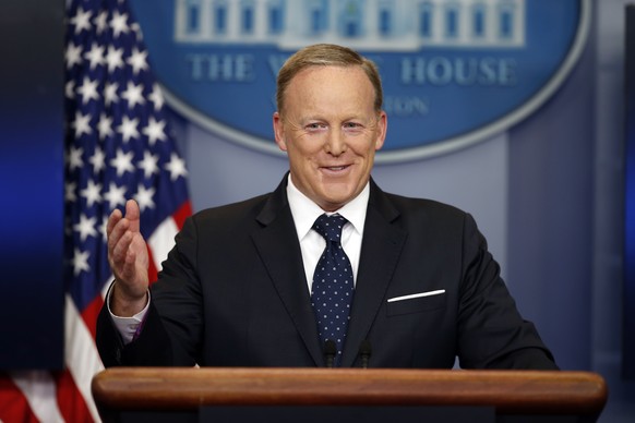 FILE - In this Tuesday, June 20, 2017, file photo, then-White House press secretary Sean Spicer smiles as he answers a question during a briefing at the White House, in Washington. A black man has acc ...