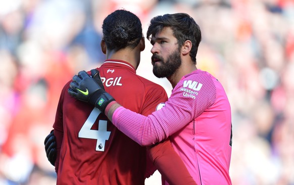 epa07564829 Liverpool&#039;s Virgil Van Dijk (L) and Alisson Becker (R) react after winning the English Premier League match between Liverpool FC and Wolverhampton Wanderers FC at Anfield, Liverpool,  ...