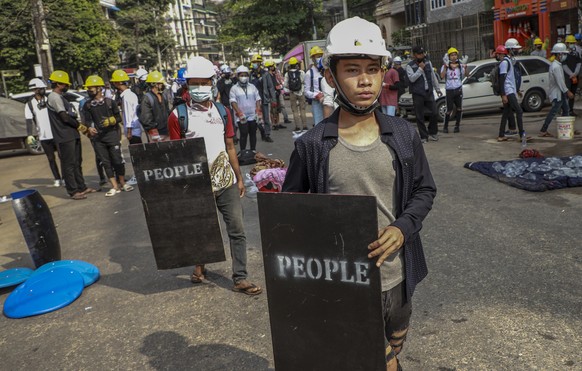 Anti-coup protesters with makeshift shields stand in Yangon, Myanmar Wednesday, March 3, 2021. Demonstrators in Myanmar took to the streets again on Wednesday to protest last month&#039;s seizure of p ...