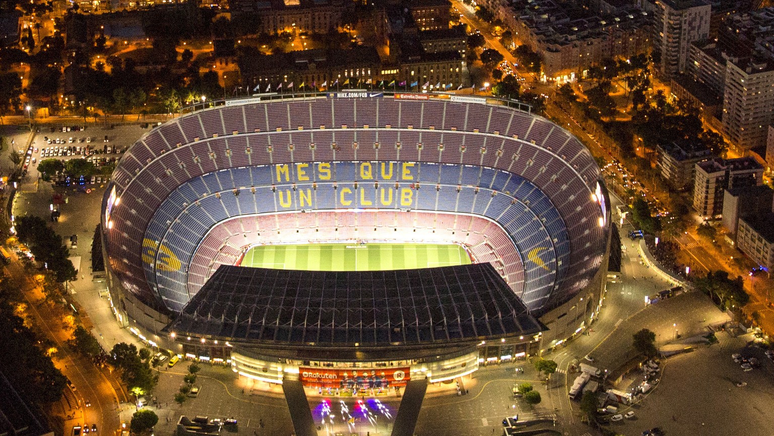 FILE - In this Tuesday, Sept. 19, 2017 file photo, the Camp Nou stadium is illuminated in Barcelona, Spain. (AP Photo/Emilio Morenatti, File)