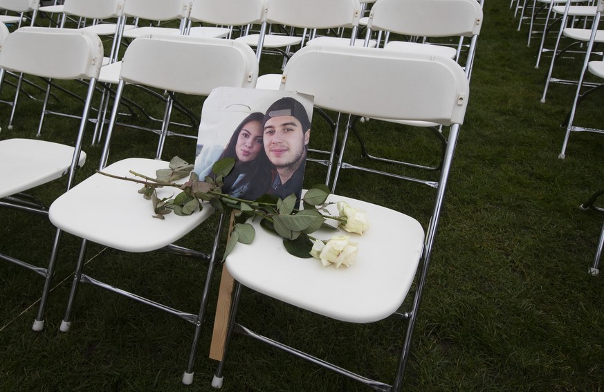 A picture of Bryce Fredriksz and his girlfriend Daisy is placed amidst 298 empty chairs, each chair for one of the 298 victims of the downed Malaysia Air flight MH17, in a park opposite the Russian em ...