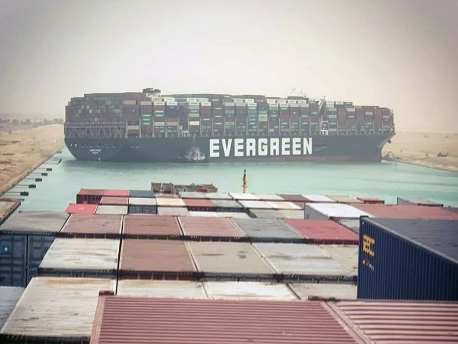 epa09092812 The Suez Canal is blocked by a large container ship in Cairo, Egypt, 24 March 2021 A large container ship registered in Panama ran aground in the Suez Canal on 23 March, blocking passage o ...