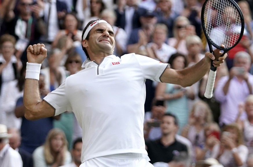 epa07713078 Roger Federer of Switzerland celebrates winning against Rafael Nadal of Spain during their semi final match for the Wimbledon Championships at the All England Lawn Tennis Club, in London,  ...