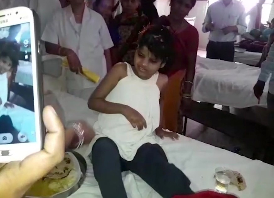 A young Indian girl sits on a bed in a hospital in this image taken from video in Bahraich northern India Thursday April 6, 2017. Indian police are reviewing reports of missing children from recent ye ...