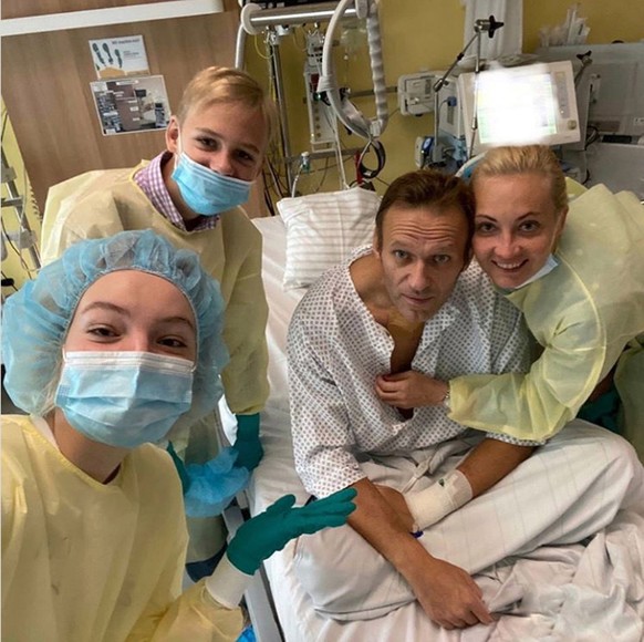 epa08670086 A undated, recent handout photo made available by Russian opposition leader Alexei Navalny via his Instagram site shows Navalny (2-R) at his Charite hospital bed where he is hospitalized i ...