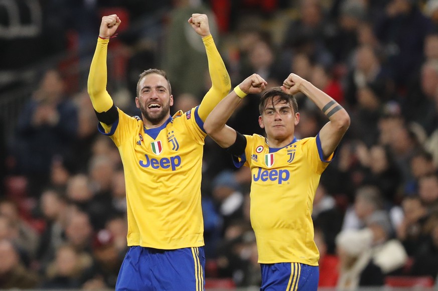Juventus&#039; Paulo Dybala, right, celebrates with his teammate Gonzalo Higuain after scoring his side second goal during the Champions League, round of 16, second-leg soccer match between Juventus a ...