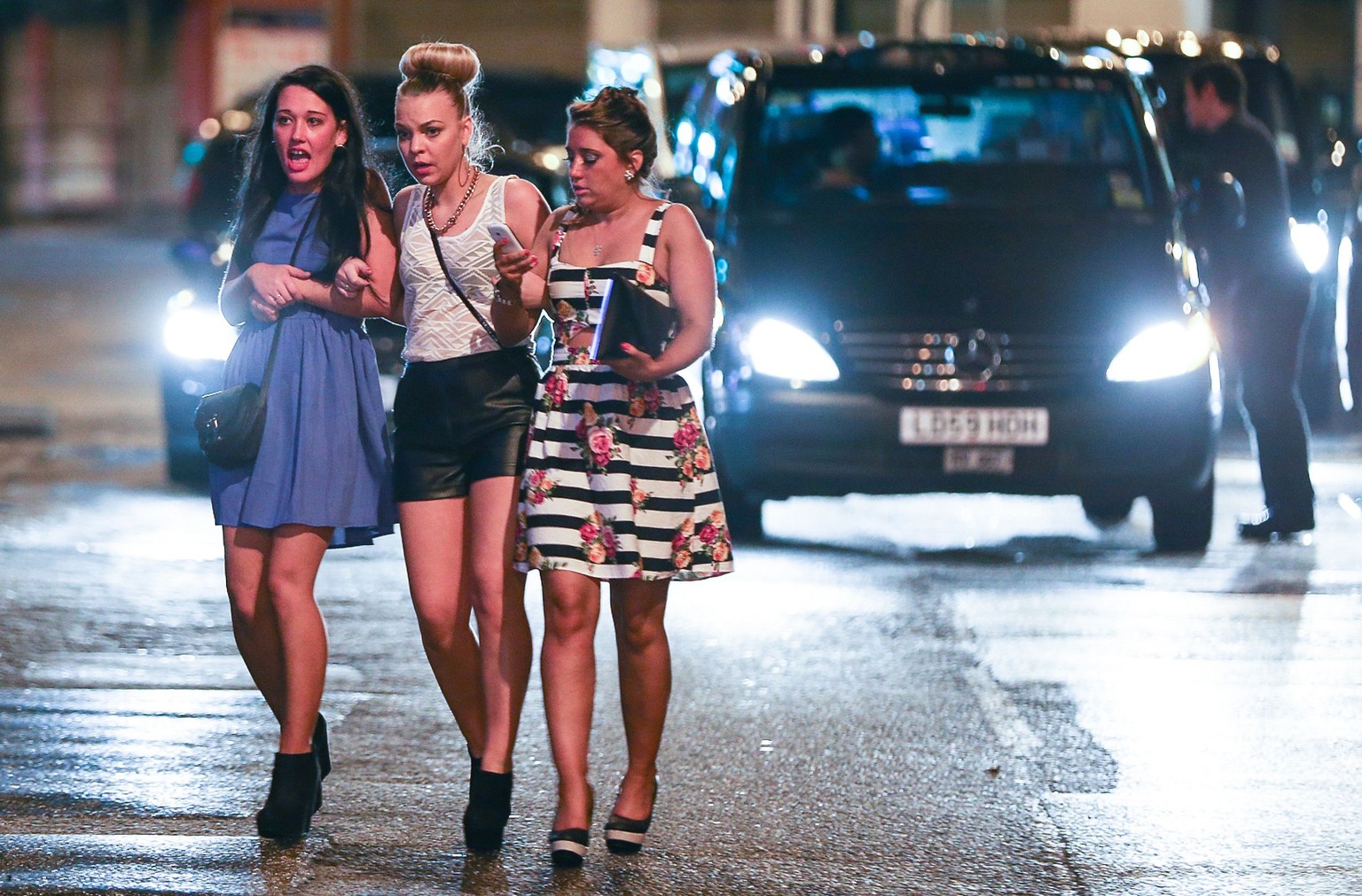Mandatory Credit: Photo by London News Pictures/REX/Shutterstock (3466396f)
Three women cross the street towards the Printworks nightclub venue
New Year&#039;s celebrations, Manchester, Britain - 31 ...