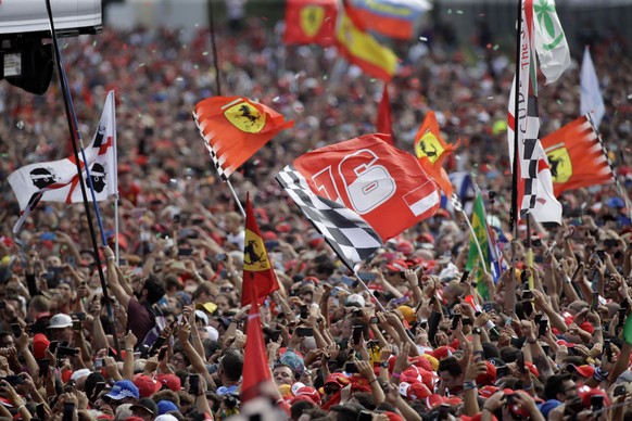 Ferrari fans celebrates after Ferrari driver Charles Leclerc of Monaco winning the Formula One Italy Grand Prix at the Monza racetrack, in Monza, Italy, Sunday, Sept. 8, 2019. (AP Photo/Luca Bruno)