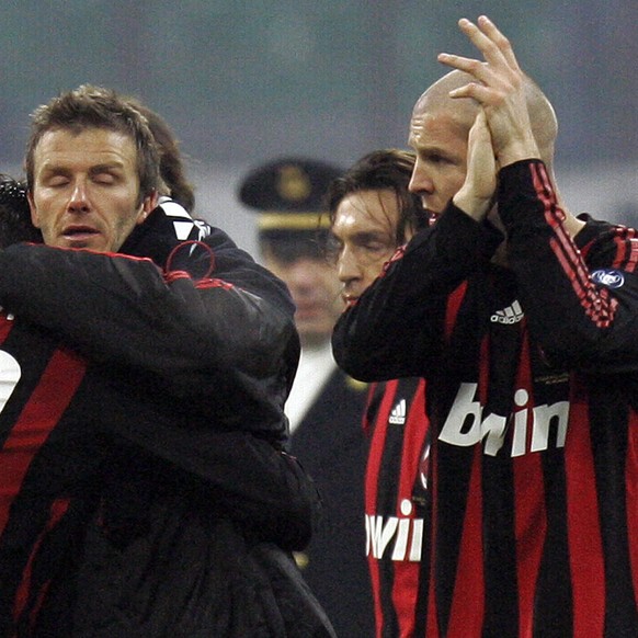 From left, AC Milan Brazilian forward Kaka, n. 22, hugs teammate David Beckham as Philippe Senderos of Switzerland claps on, after the end of the Italian Serie A soccer match between AC Milan and Fior ...