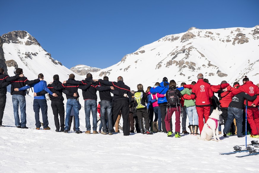 epa07385294 People get together for a minute of silence in memory of the families affected by the avalanche in the ski resort of Crans-Montana, Switzerland, 21 February 2019. Several skiers were swept ...