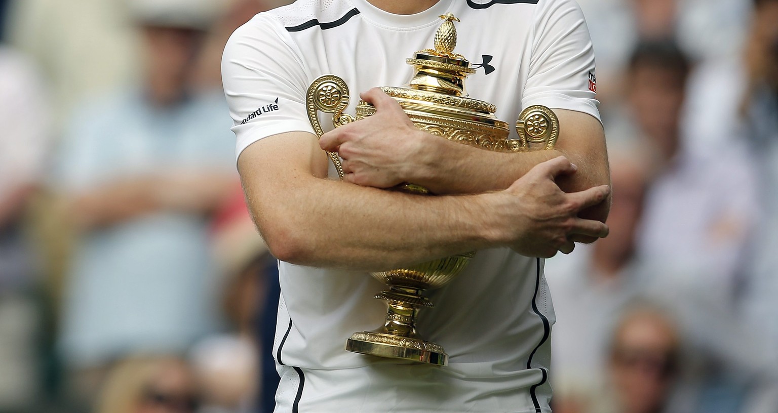 epa05418843 Andy Murray of Britain with the championship trophy following his win over Milos Raonic of Canada in the men&#039;s singles final of the Wimbledon Championships at the All England Lawn Ten ...