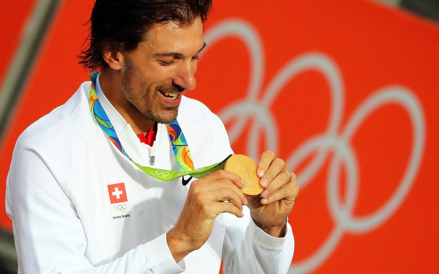 epa05470794 Fabian Cancellara of Switzerland looks at his gold medal on the podium after winning the men&#039;s Individual Time Trial of the Rio 2016 Olympic Games Road Cycling events at Pontal in Rio ...