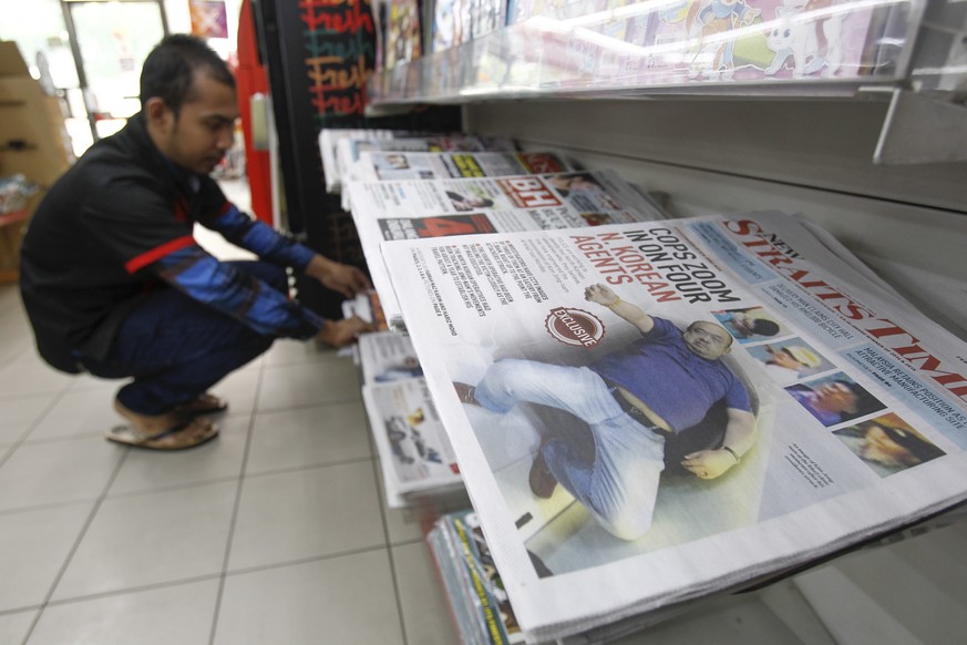 A man arranges the newspaper to the rack inside a mini mart in Kuala Lumpur, Malaysia Saturday, Feb. 18, 2017. North Korea said it will reject the results of an autopsy on its leader&#039;s estranged  ...