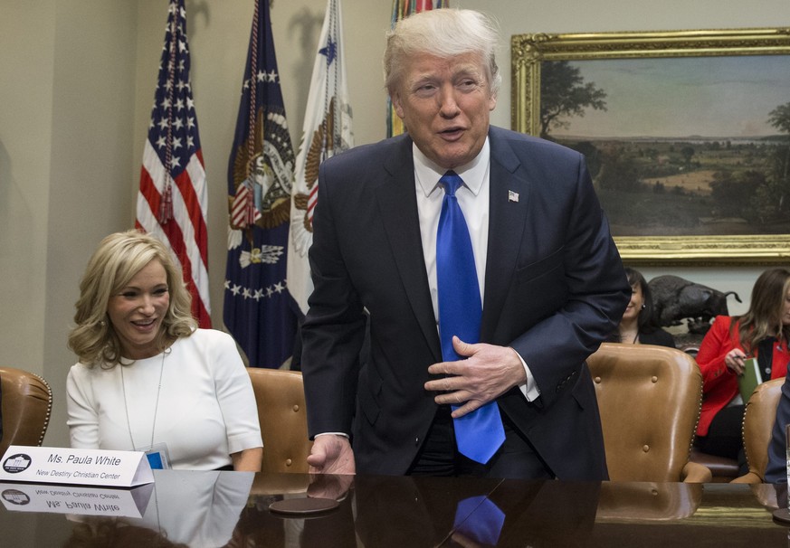 epa05765068 US President Donald J. Trump (C) takes his seat between Paula White (L) of the New Destiny Christian Center and Executive Vice President and CEO of the National Rifle Association (NRA) Way ...