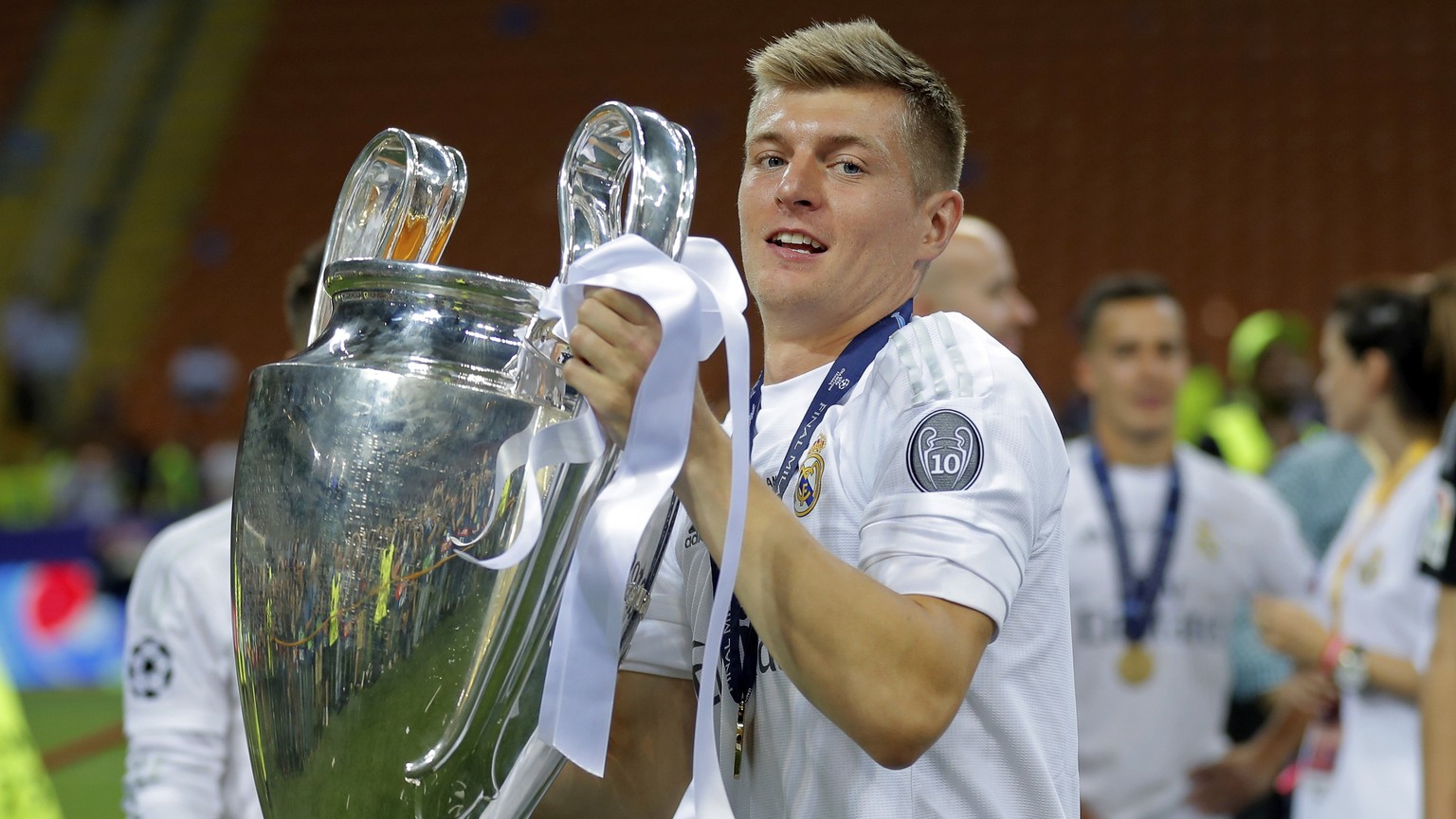 FILE - In this May 28, 2016 file photo, Real Madrid&#039;s Toni Kroos celebrates with the trophy after the Champions League final soccer match between Real Madrid and Atletico Madrid at the San Siro s ...
