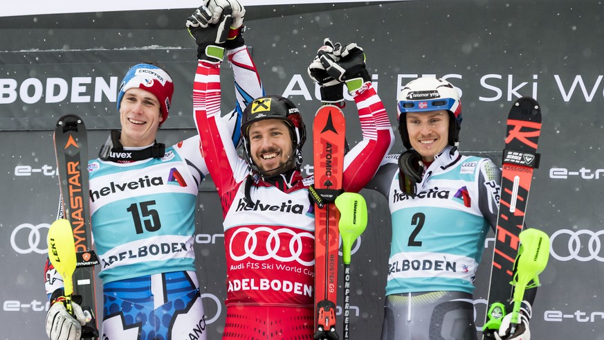 Second placed Clement Noel of France, left, winner Marcel Hirscher of Austria, center, and third placed Henrik Kristoffersen of Norway, right, celebrate on the podium after the second run of the men&# ...