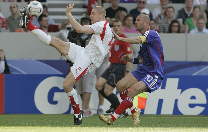 Switzerland&#039;s Philippe Senderos, left, gets the ball ahead of France&#039;s Zinedine Zidane, right, during the France v Switzerland Group G soccer match at the World Cup Gottlieb-Daimler stadium  ...