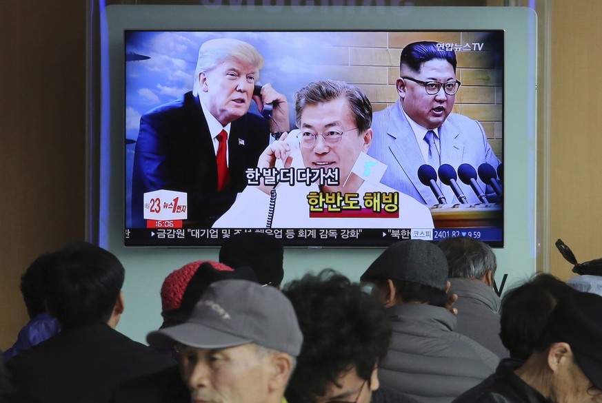 People watch a TV screen showing images of North Korean leader Kim Jong Un, right, South Korean President Moon Jae-in, center, and U.S. President Donald Trump at the Seoul Railway Station in Seoul, So ...