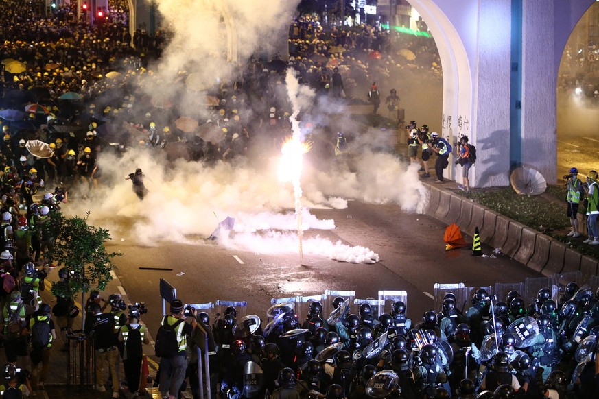 Protesters are engulfed by teargas during a confrontation with riot police in Hong Kong Sunday, July 21, 2019. Hong Kong police launched tear gas at protesters Sunday after a massive pro-democracy mar ...