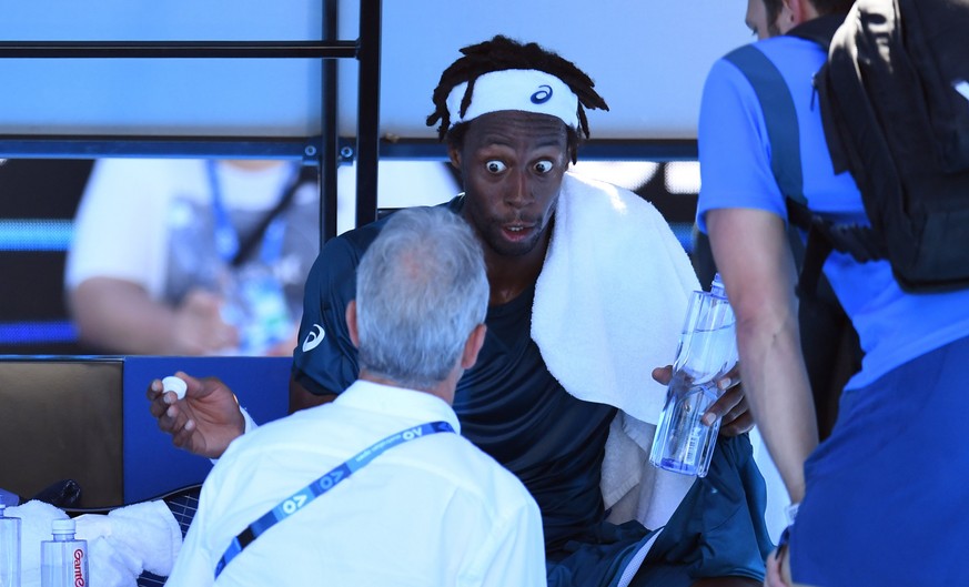 epa06448881 Gael Monfils of France (C) reacts during a break in play against Novak Djokovic of Serbia during round two on day four of the Australian Open tennis tournament in Melbourne, Victoria, Aust ...