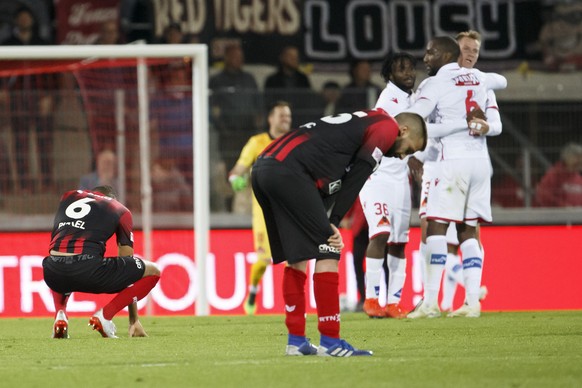 Xamax&#039;s midfielder Charles Pickel, left, and defender Igor Djuric, 2nd right, past Sion&#039;s players react after losing against Sion, during the Super League soccer match of Swiss Championship  ...