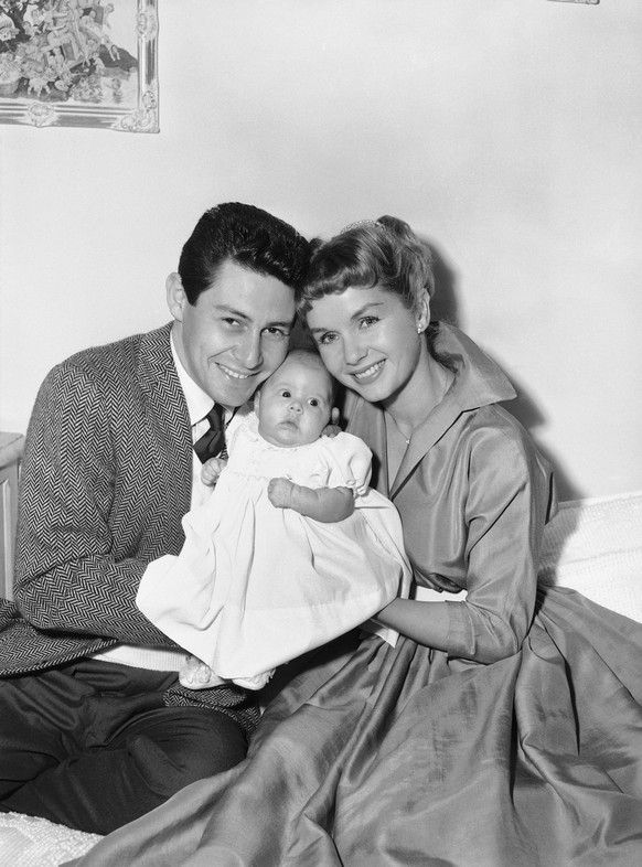 FILE - In this Jan. 2, 1957 file photo, Eddie Fisher and Debbie Reynolds hold their baby daughter, Carrie Frances Fisher, as the pose for a photo in the Hollywood area of Los Angeles. On Tuesday, Dec. ...