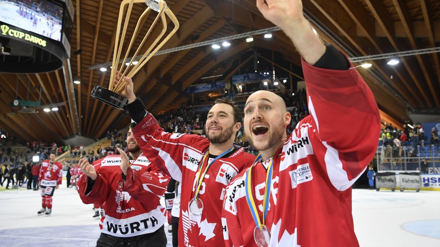 Team Canada&#039;s Pierre-Alexandre Parenteau and Maxim Noreau, from left, with the Trophy after winning the final game between Team Canada and Team Suisse at the 91th Spengler Cup ice hockey tourname ...