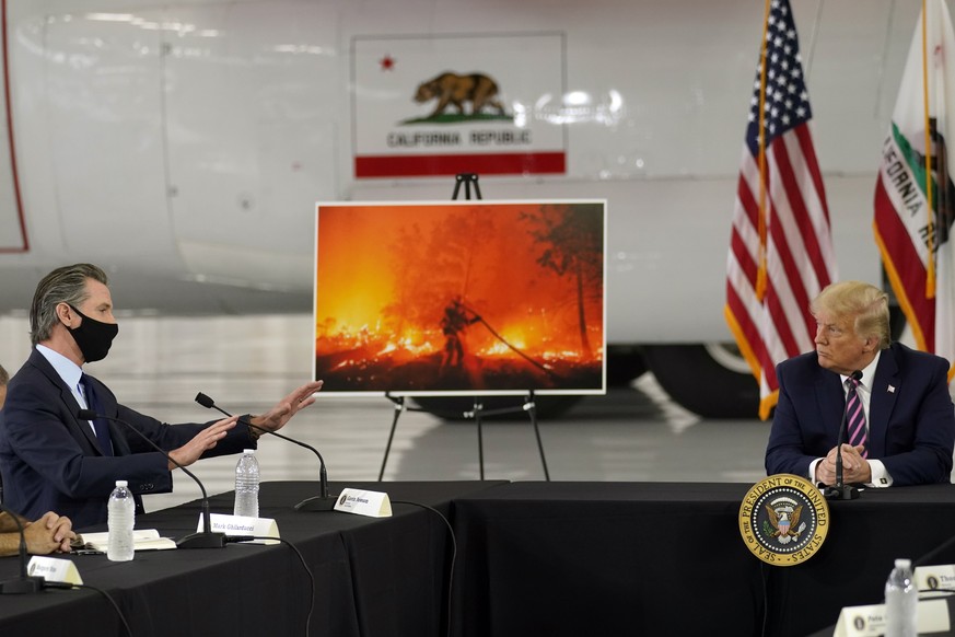 President Donald Trump listens as California Gov. Gavin Newsom speaks during a briefing at Sacramento McClellan Airport, in McClellan Park, Calif., Monday, Sept. 14, 2020, on the western wildfires. (A ...