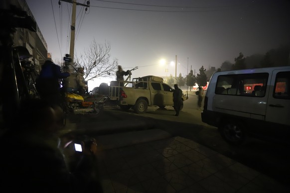 epa06458656 Afghan security officials take up positions near the scene of attack by armed men at an upscale hotel in Kabul, Afghanistan, 20 January 2018. A group of armed insurgents attacked Kabul&#03 ...
