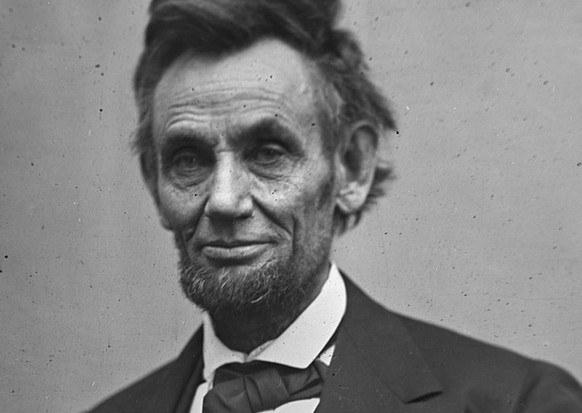 In this photo provided by the Library of Congress, Abraham Lincoln is pictured in a three-quarter length portrait, seated and holding his spectacles and a pencil. This image was taken by photographer  ...