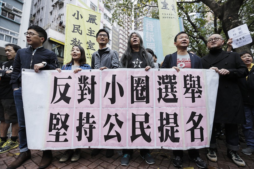 epa05871069 Hong Kong lawmakers (2nd L to R) Nathan Law, Lau Siu-lai, Eddie Chu, Leung Kwok-hung (also known as &#039;Long Hair&#039;), Raymond Chan and Shiu Ka-chun shout slogans during a rally held  ...